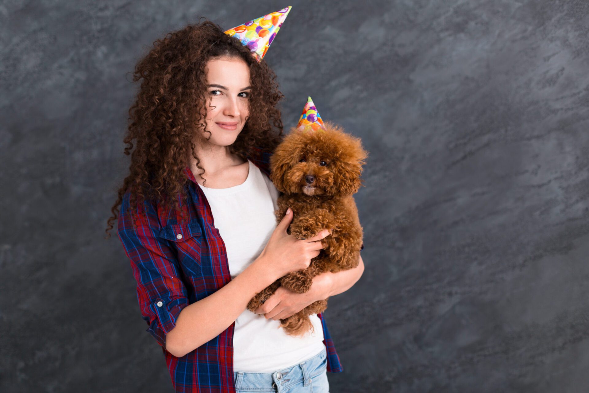 Young,Woman,And,Her,Poodle,Puppy,In,Party,Hats,,Celebrate Pet policy